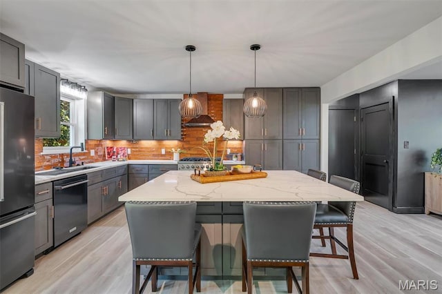 406 Meyer Ave, Saint Louis, MO 63122 - kitchen featuring dishwasher, freestanding refrigerator, a breakfast bar, backsplash, and light stone counters