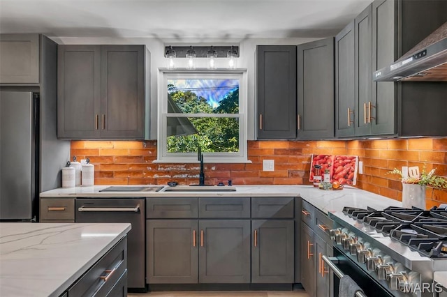 406 Meyer Ave, Saint Louis, MO 63122 - kitchen with appliances with stainless steel finishes, exhaust hood, tasteful backsplash, light stone counters, and gray cabinets