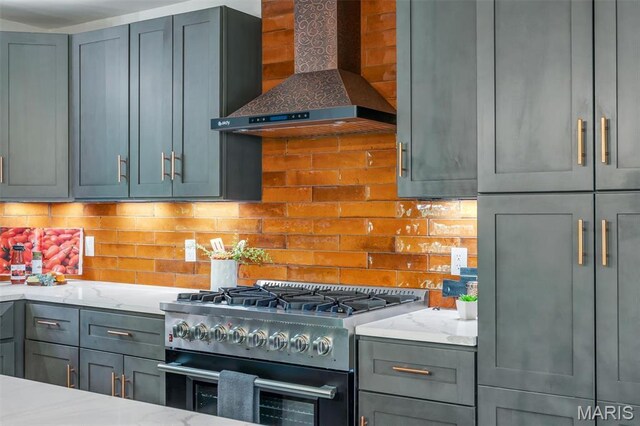 406 Meyer Ave, Saint Louis, MO 63122 - kitchen featuring high end range, wall chimney range hood, tasteful backsplash, light stone countertops, and gray cabinets