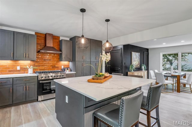 406 Meyer Ave, Saint Louis, MO 63122 - kitchen featuring wall chimney range hood, stainless steel stove, light wood-style flooring, backsplash, and recessed lighting
