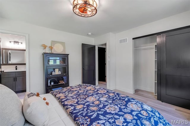 406 Meyer Ave, Saint Louis, MO 63122 - bedroom featuring light wood-style flooring, a closet, and ensuite bathroom