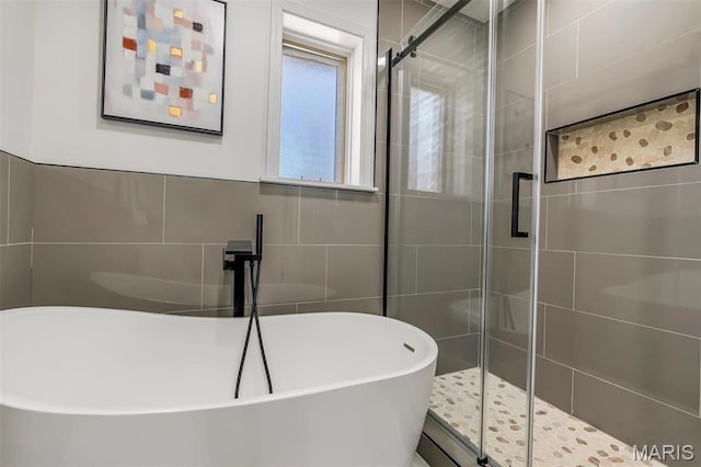 406 Meyer Ave, Saint Louis, MO 63122 - bathroom featuring a stall shower, a freestanding tub, and tile walls