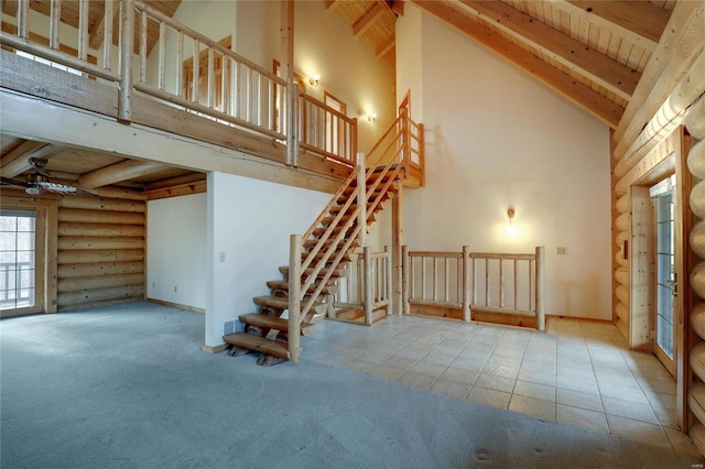 basement with ceiling fan, stairway, carpet flooring, and tile patterned floors