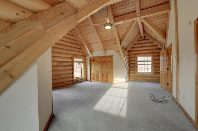 bonus room with rustic walls, wood ceiling, plenty of natural light, carpet flooring, and ceiling fan