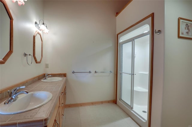 bathroom featuring a shower stall and double vanity