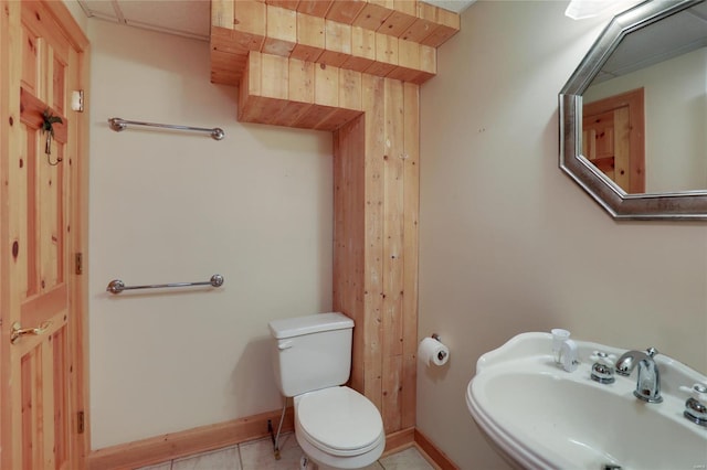 bathroom featuring a sink, toilet, and baseboards