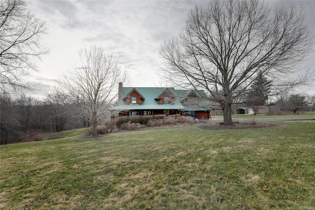 view of front of property with a front yard and a chimney