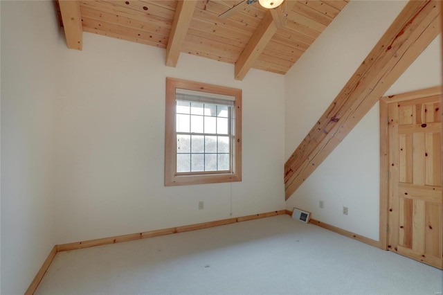 carpeted spare room with baseboards and wood ceiling