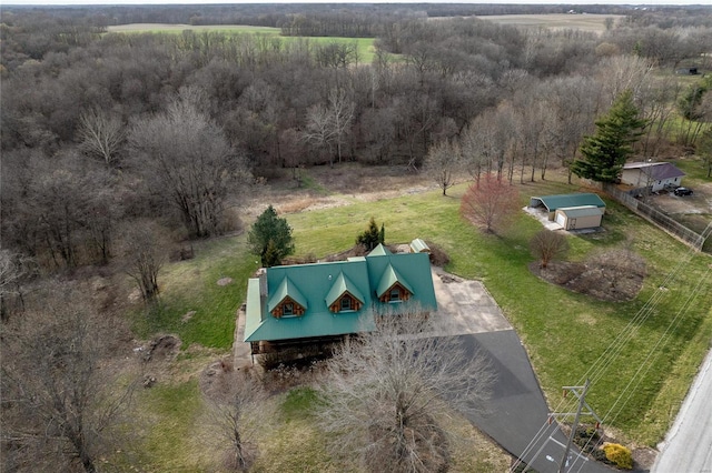 aerial view of property and surrounding area featuring a heavily wooded area