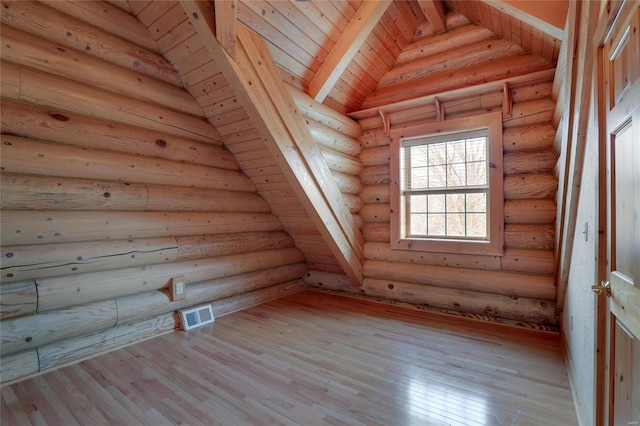 bonus room featuring wood finished floors and vaulted ceiling