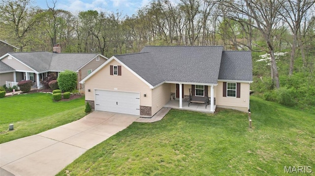 view of front of home with driveway, a porch, an attached garage, and a front yard
