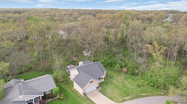 view of subject property featuring a heavily wooded area
