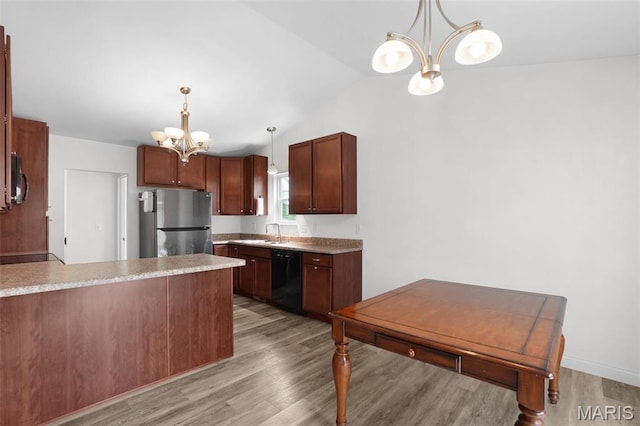 kitchen with freestanding refrigerator, a chandelier, black dishwasher, light wood-style flooring, and a peninsula