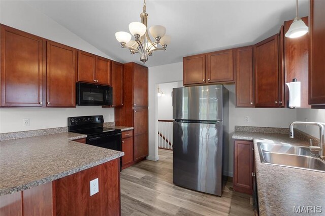 kitchen with black appliances, a sink, light wood finished floors, a chandelier, and decorative light fixtures