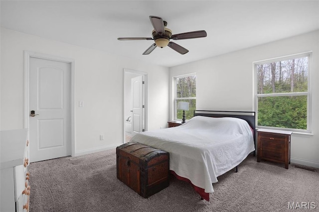 bedroom featuring carpet flooring, baseboards, ceiling fan, and ensuite bath