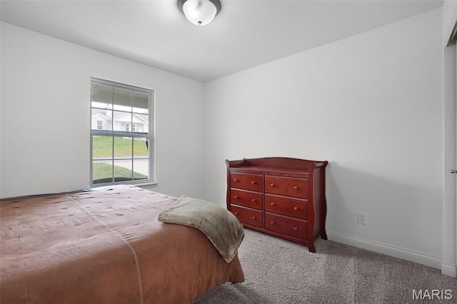 carpeted bedroom featuring baseboards