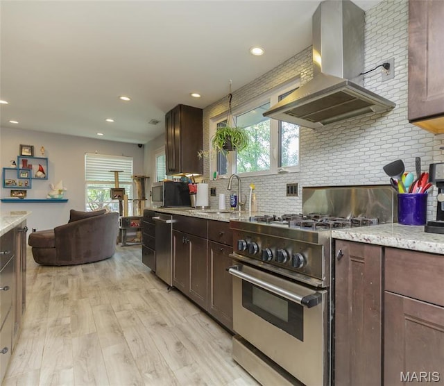 86 Pebblebrook Ln, Saint Louis, MO 63146 - kitchen with appliances with stainless steel finishes, wall chimney range hood, a sink, healthy amount of natural light, and recessed lighting