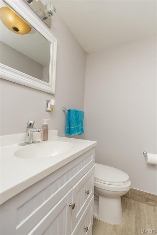 86 Pebblebrook Ln, Saint Louis, MO 63146 - bathroom featuring wood finished floors, vanity, toilet, and baseboards