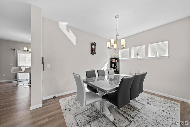 905 Sugar Pear St, Saint Charles, MO 63301 - dining area with a chandelier, wood finished floors, and baseboards
