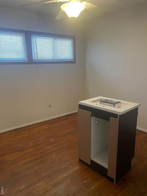 310 Pleasant Ave, Bland, MO 65014 - spare room featuring dark wood finished floors, baseboards, and ceiling fan