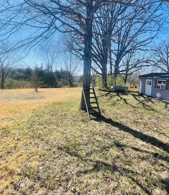 310 Pleasant Ave, Bland, MO 65014 - view of green lawn with an outbuilding and a storage shed