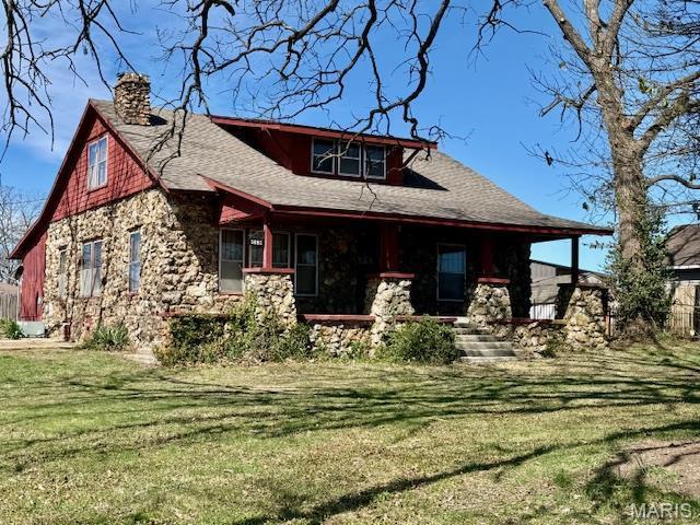 1681 S US Highway 63, West Plains, MO 65775 - rear view of house featuring a chimney, stone siding, a yard, a porch, and roof with shingles