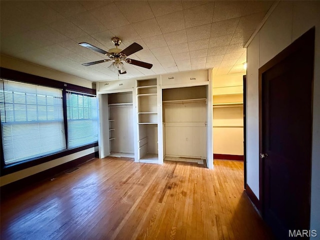 1681 S US Highway 63, West Plains, MO 65775 - unfurnished bedroom featuring baseboards, light wood-type flooring, and a ceiling fan
