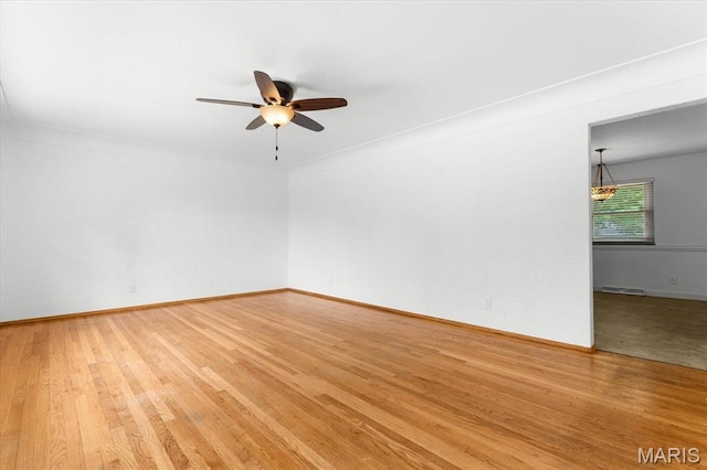 304 S Augusta St, Ofallon, IL 62269 - empty room featuring ceiling fan, light wood finished floors, and baseboards
