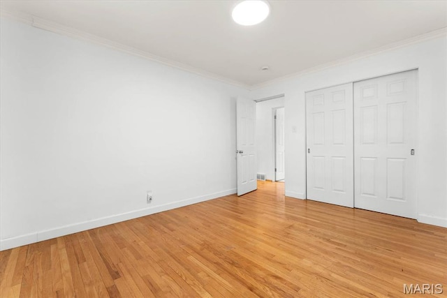304 S Augusta St, Ofallon, IL 62269 - unfurnished bedroom with crown molding, light wood-style flooring, baseboards, and a closet