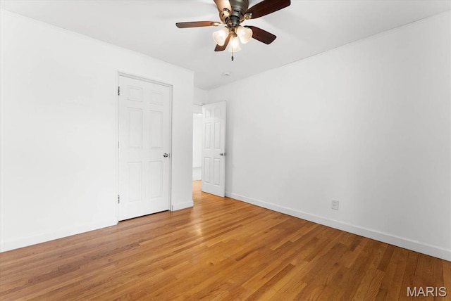 304 S Augusta St, Ofallon, IL 62269 - empty room featuring light wood finished floors, ceiling fan, and baseboards