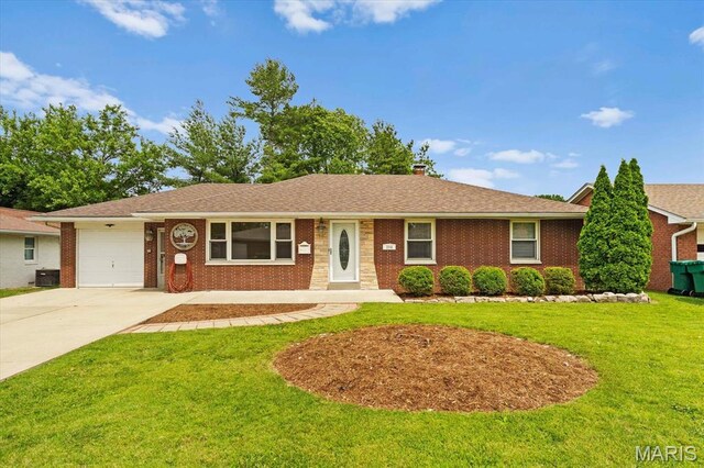 304 S Augusta St, Ofallon, IL 62269 - ranch-style house with concrete driveway, an attached garage, a front lawn, brick siding, and central air condition unit