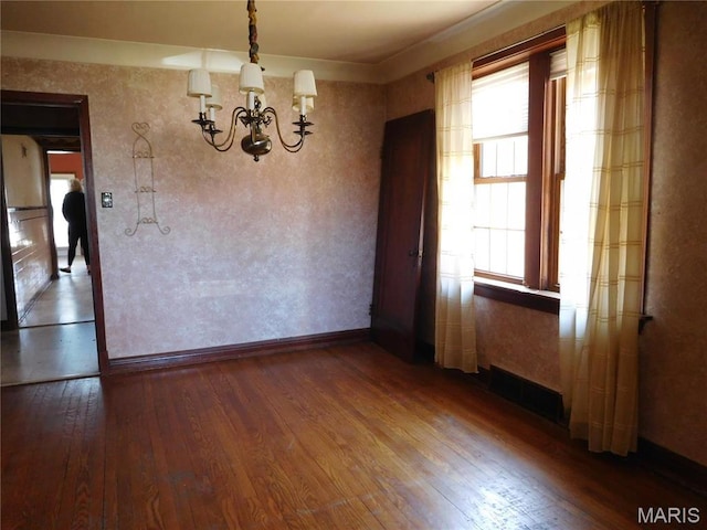 6432 Lansdowne Ave, Saint Louis, MO 63109 - unfurnished dining area featuring a chandelier, hardwood / wood-style flooring, and baseboards