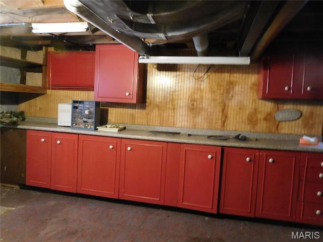 6432 Lansdowne Ave, Saint Louis, MO 63109 - kitchen featuring red cabinets, wood walls, and light countertops