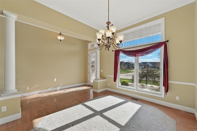 2707 Fairway Estates Dr, Wentzville, MO 63385 - unfurnished dining area with ornate columns, a chandelier, baseboards, wood finished floors, and ornamental molding