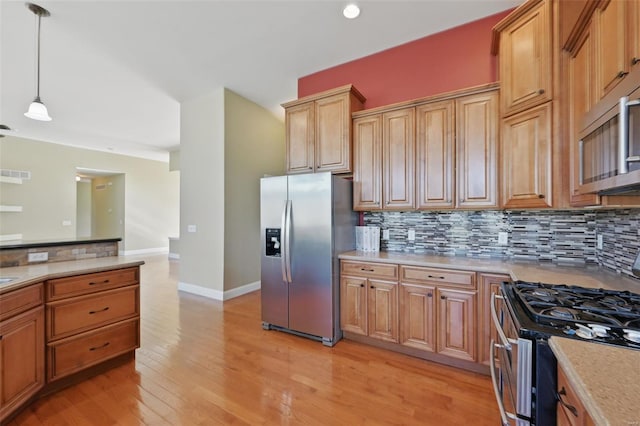 2707 Fairway Estates Dr, Wentzville, MO 63385 - kitchen featuring appliances with stainless steel finishes, tasteful backsplash, light wood-style flooring, decorative light fixtures, and recessed lighting