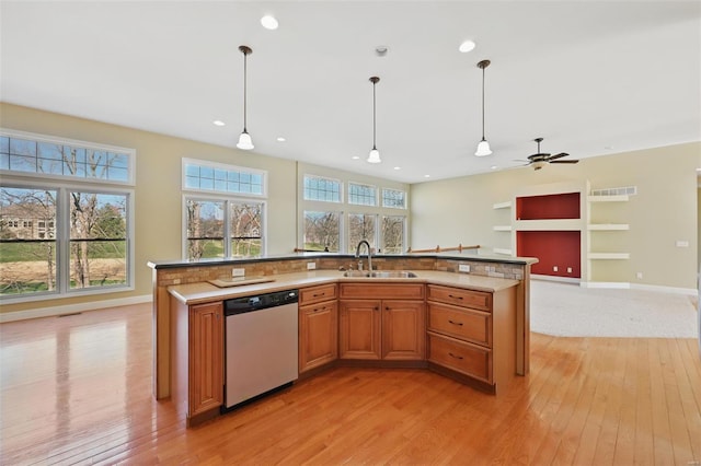 2707 Fairway Estates Dr, Wentzville, MO 63385 - kitchen with dishwasher, a sink, light wood-style floors, open floor plan, and decorative light fixtures