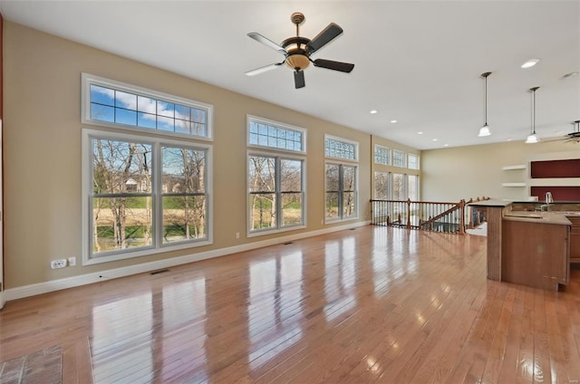 2707 Fairway Estates Dr, Wentzville, MO 63385 - unfurnished living room featuring ceiling fan, light wood-style floors, recessed lighting, and baseboards