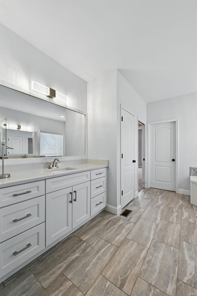 2707 Fairway Estates Dr, Wentzville, MO 63385 - full bathroom featuring vanity, baseboards, and wood tiled floors