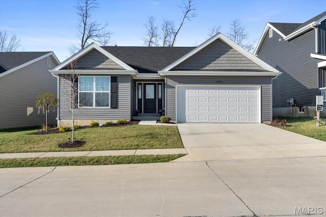16783 River Stone Dr, Florissant, MO 63031 - view of front of house with an attached garage, a front lawn, and driveway
