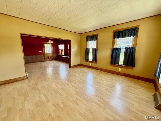 201 W Barr Ave, Jerseyville, IL 62052 - spare room featuring wood finished floors, plenty of natural light, and baseboards