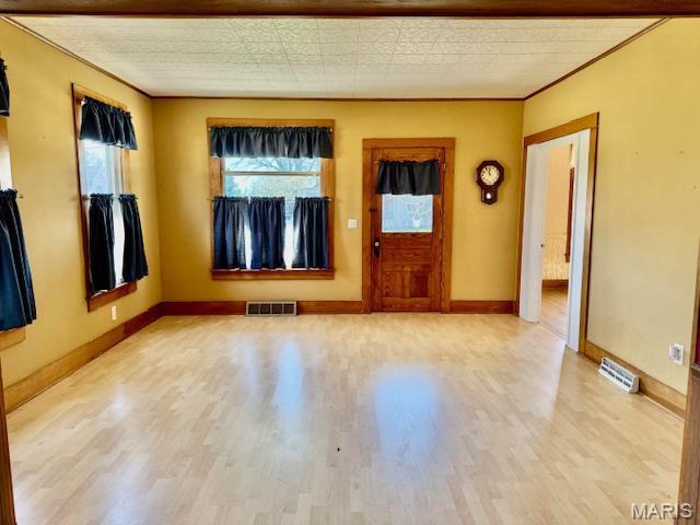 201 W Barr Ave, Jerseyville, IL 62052 - entryway with light wood-style flooring, baseboards, and crown molding