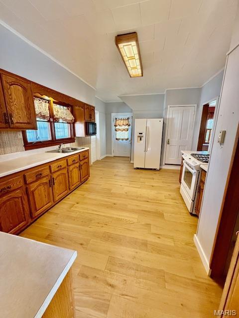 201 W Barr Ave, Jerseyville, IL 62052 - kitchen with white appliances, a sink, light wood finished floors, ornamental molding, and brown cabinetry