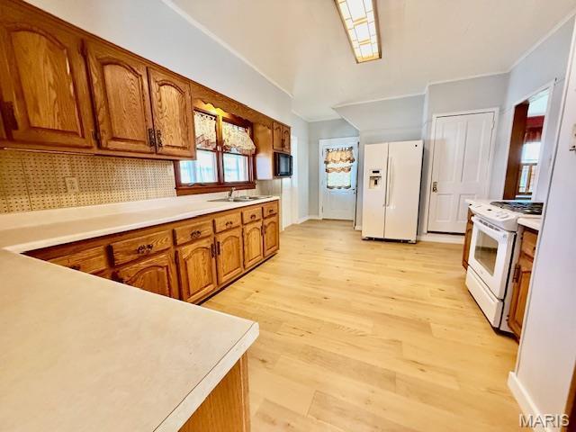 201 W Barr Ave, Jerseyville, IL 62052 - kitchen with white appliances, brown cabinetry, light wood-type flooring, light countertops, and crown molding
