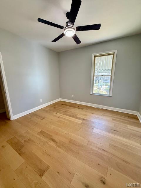 201 W Barr Ave, Jerseyville, IL 62052 - empty room with light wood-style floors, baseboards, and a ceiling fan