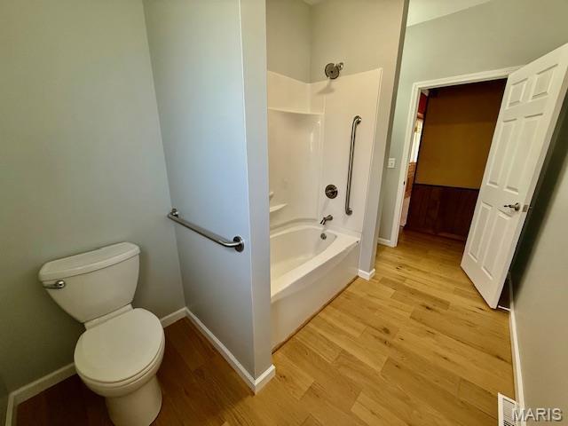 201 W Barr Ave, Jerseyville, IL 62052 - full bath with wood finished floors, shower / tub combination, baseboards, and toilet