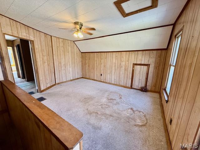 201 W Barr Ave, Jerseyville, IL 62052 - empty room featuring wooden walls, a ceiling fan, and light carpet