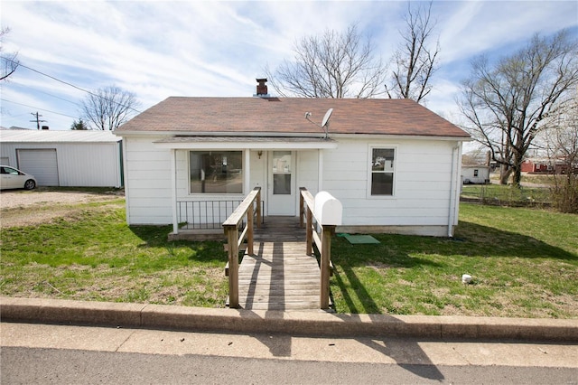 106 N A St, Cuba, MO 65453 - view of front of home with a front yard, a shingled roof, covered porch, and a chimney