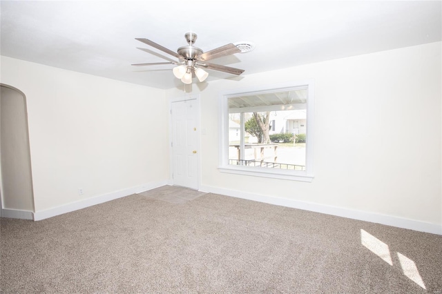 106 N A St, Cuba, MO 65453 - empty room featuring arched walkways, carpet, a ceiling fan, and baseboards