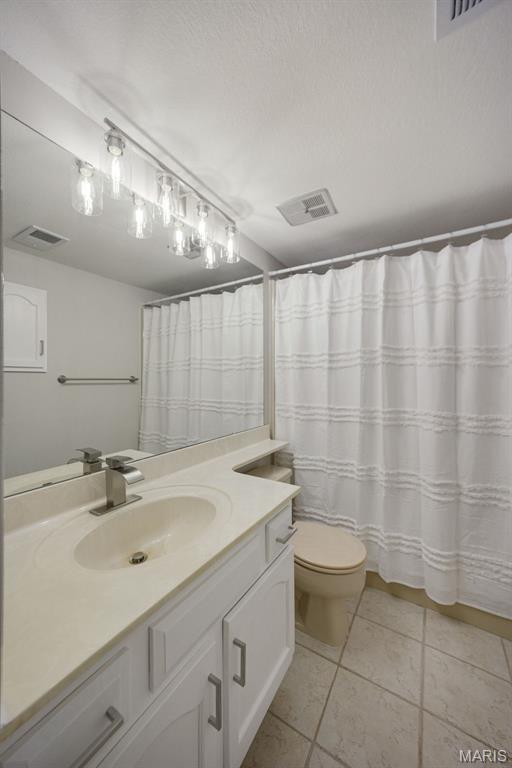 1420 Heritage Lndg Unit 207, Saint Charles, MO 63303 - full bathroom featuring vanity, tile patterned flooring, and toilet
