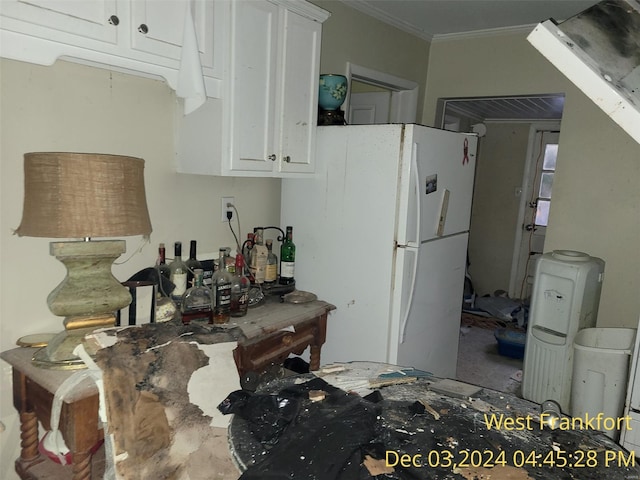 310 S Odle, West Frankfort, IL 62896 - kitchen with white cabinets, ornamental molding, and freestanding refrigerator